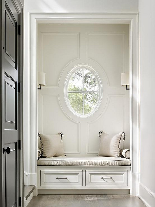 Built-in with Built in Window Seat Nook with Window. This foyer features a nook filled with a built-in window seat with drawers illuminated by oil-rubbed bronze sconces and black front door. Beth Webb Interiors. 