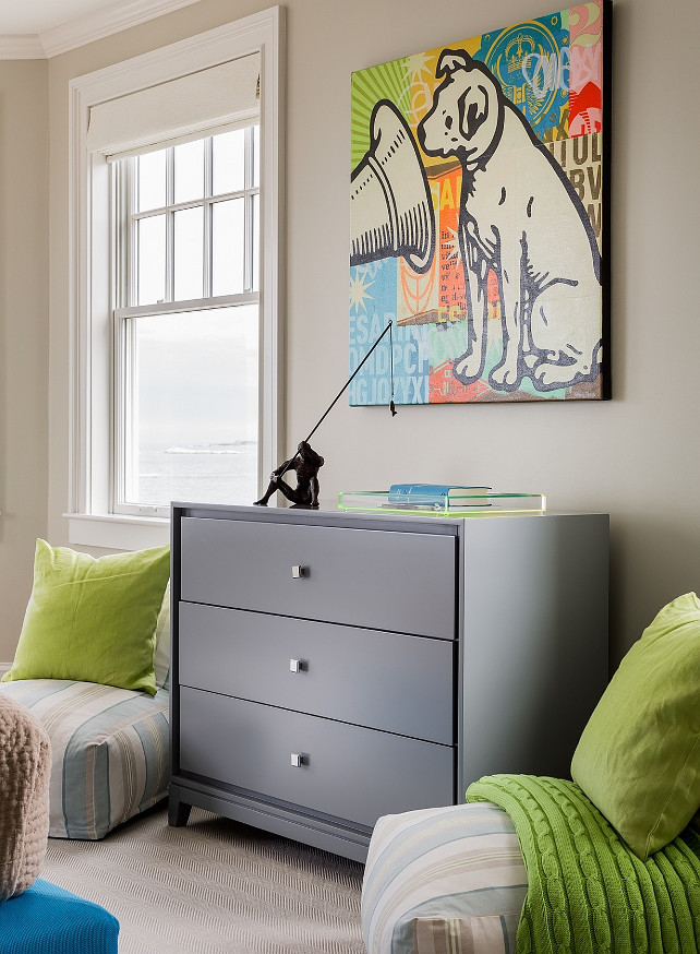 Boys Bedroom Furniture. Contemporary boy's room features a pair of blue and beige low lounge chairs adorned with lime green pillows flanking a gray dresser topped with a lucite tray and pop art. #BoysBedroom #Furniture