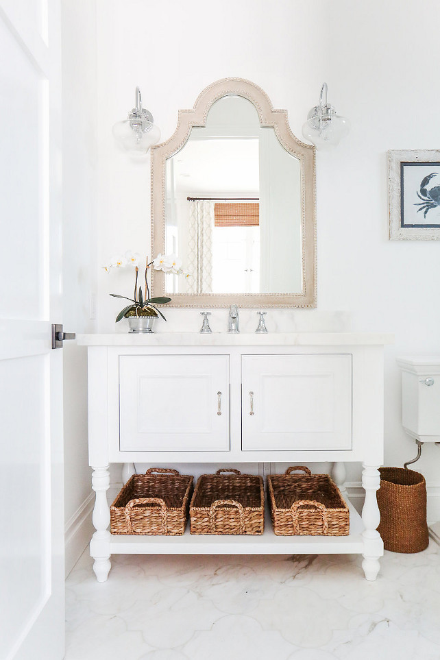 Coastal Bathroom. Coastal bathroom with white vanity with marble countertop and Arabesque marble flooring. #CoastalBathroom #Whitevanity #BathroomMarbleCountertop #BathroomMarbleFlooring #CoastalInteriors Blackband Design.
