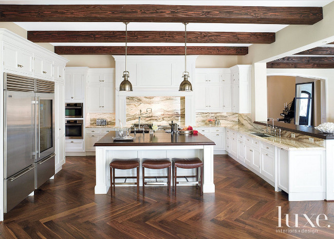 Kitchen Herringbone hardwood floors. Kitchen Herringbone hardwood floor ideas. Kitchen Herringbone hardwood floor design. Kitchen with onyx travertine countertop and hand-scraped walnut floor assembled in a herringbone pattern. #Kitchen #Herringbone #hardwoodfloors John Granen Photography. 