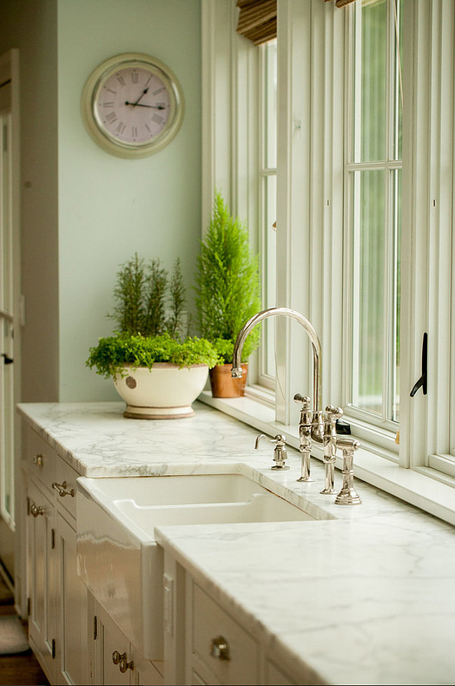 Farmhouse kitchen with Calacatta Gold Marble Kitchen Countertop. Farmhouse kitchen sink. Farmhouse kitchen trim paint color is Benjamin Moore White Dove. #BenjaminMoorewhitedove #Farmhouse #kitchen Connecticut Stone.