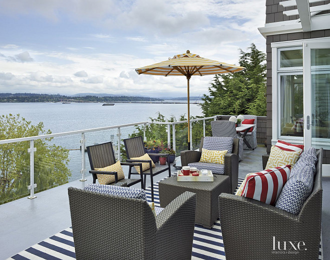Deck. Deck Furniture. Design your deck like a designer. he wicker furniture by Brown Jordan was acquired through Terris Draheim and sports blue-and-white Clarence House cushion fabric. A jaunty umbrella by Santa Barbara designs provides shelter from the sun. #Deck #DeckDesign GR Interiors.