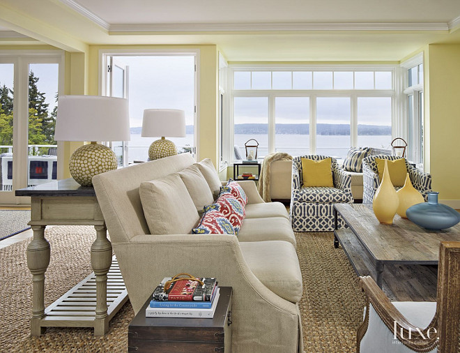 Living Room. Beach House living room color ideas. Linen Lee Industries sofas contrasts with Fabricut’s Ikat print on the pillows and a Schumacher fabric on the Lee Industries chairs in this living room. #LivingRoom GR Interiors.