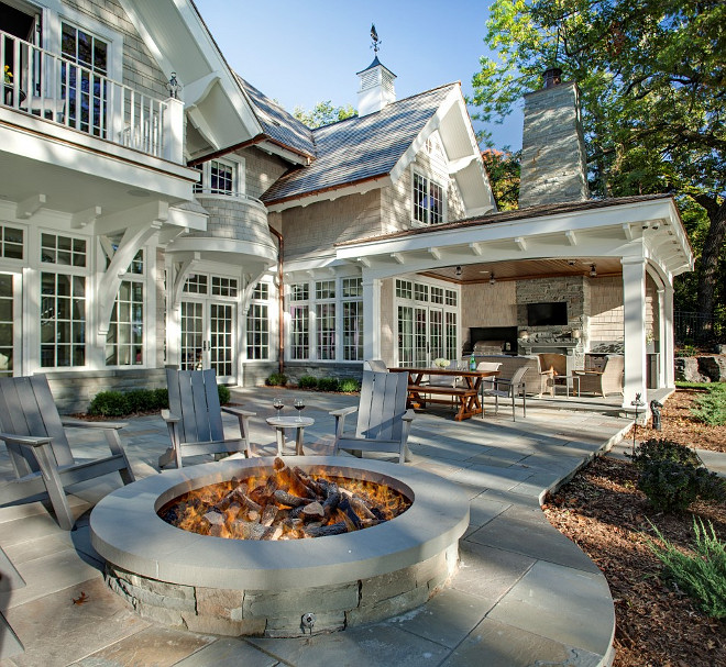 Backyard with large stone patio with fire pit, outdoor fireplace and outdoor kitchen. #Backyard #Firepit #Fireplace #Kitchen John Kraemer & Sons.