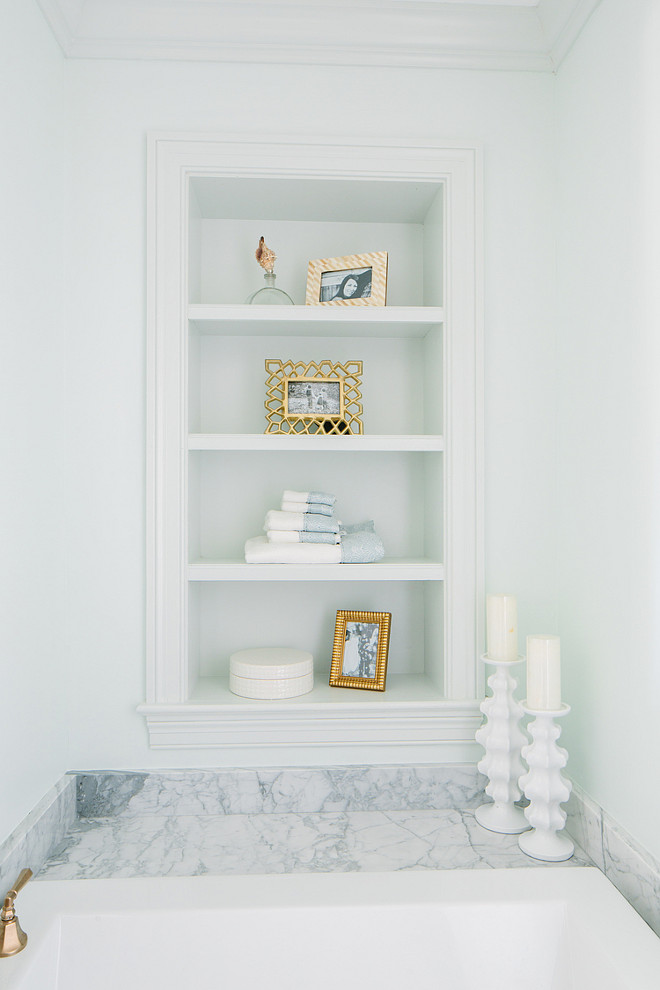 Bathtub Bookshelf Ideas. Bathtub bookshelves. Bathroom features small nook filled with bookshelves over marble clad bathtub. #Bathroom #Bathtub #Bookshelves Natalie Clayman Interior Design.