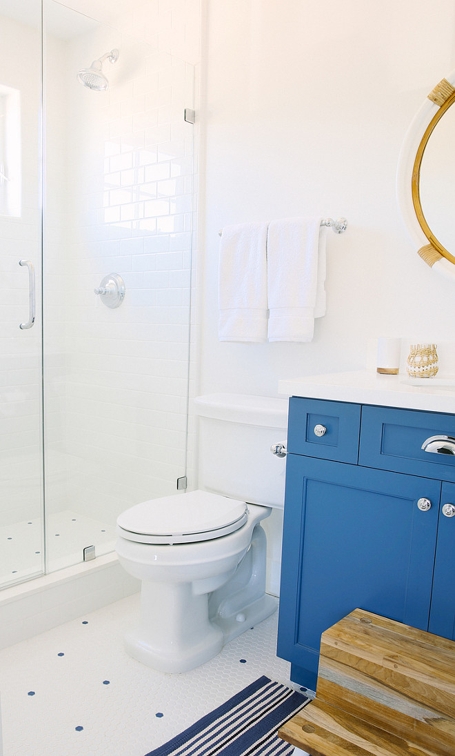 Blue and white bathroom. All white bathroom with blue cabinet. All white bathroom with blue vanity. #AllwhiteBathroom #BlueCabinet #BlueVanity Rita Chan Interiors.