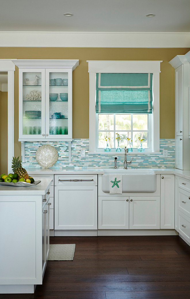 Kitchen with shimmer blue turquoise backsplash and farmhouse sink. #ShimmerBacksplash #BlueBacksplash #TurquoiseBacksplash #BeachhouseBacksplash #Kitchen #Farmhousesink JMA Interior Design.