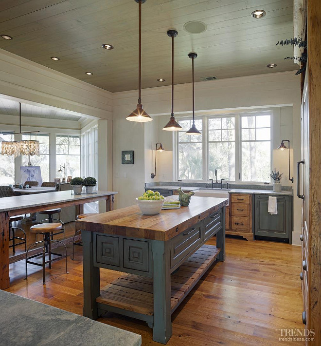 Farmhouse Kitchen Island. Farmhouse table style kitchen island with butchers block countertop. The gorgeous cabinets were custom built by John Zook. The painted cabinets are in a distressed teal green shade with a dark brown glaze finish to create a sense of patina on the cabinets. #Farmhouse #KItchen #Island #KitchenIsland Interiors by Gregory Vaughan, Kelley Designs, Inc. Photos by Atlantic Archives, Inc. 