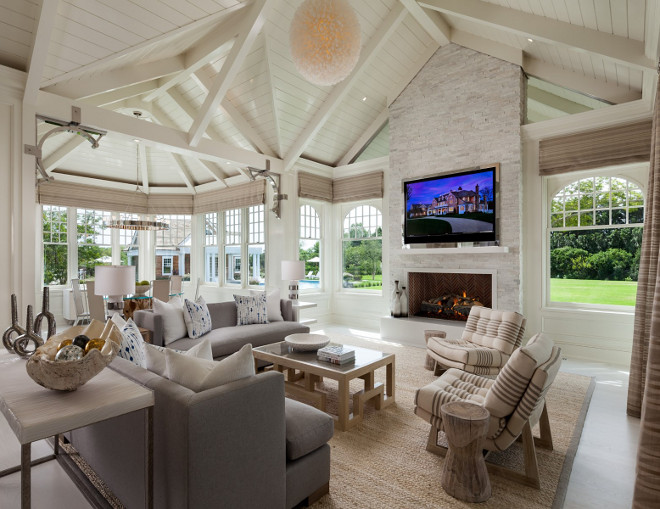 Sunroom. Ultimate sunroom in a Hamptons house with stunning architectural details, stone fireplace, beached hardwood floors and Vaulted Ceiling with exposed v shaped trusses. #Sunroom #Ceiling #VaultedCeiling #exposed #trusses Sotheby's Homes.
