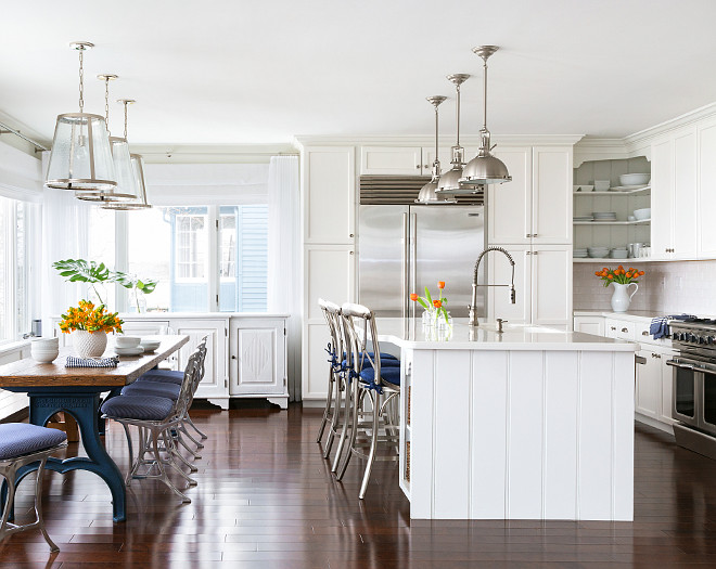 Kitchen. White kitchen painted in White Dove by Benjamin Moore. Pendants above kitchen table are from Lighting Direct. Industrial table and dining chairs are antiques. Pendants above kitchen island are Hudson Valley Lighting Massena Transitional Pendant Light. #Kitchen #KitchenIdeas Chango & Co