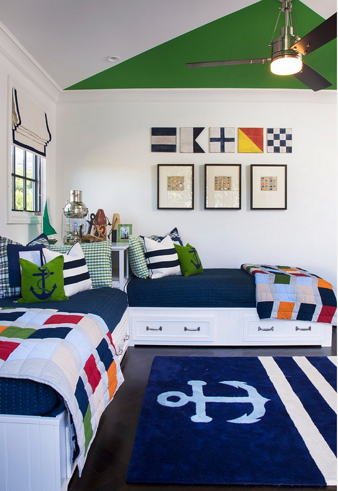 Nautical bedroom with Built in Bed. Kids bedroom with built in beds. What a great nautical bedroom! I am loving the nautical flags and the built-in beds. Shared kids bedroom with built in beds with storage under. The wall color is 8581 W Designer Grey by Frazee. #builtinBeds #Builtin #bed #Storagebed AGK Design Studio.