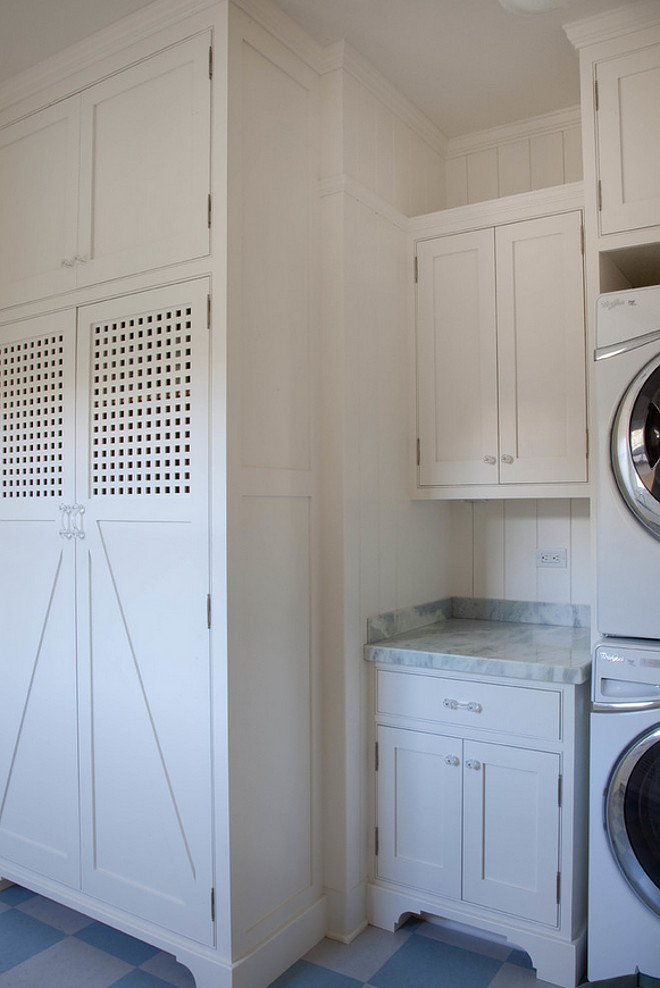 Laundry Room. Main Level Laundry Room. This Main Level Laundry room features white cabinets paired with a gray quartzite countertop and a shiplap backsplash alongside a blue checkered tiled floor. #LaundryRoom Kim Grant Design Inc.