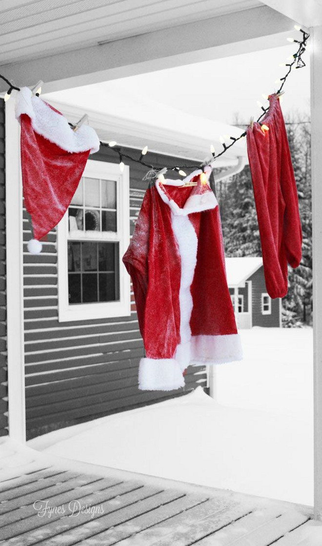 Make the kids wonder during this Christmas. Hang on the porch a Christmas Santa Suit from a string of lights Outdoor Christmas decoration. Via FYNES DESIGNS.