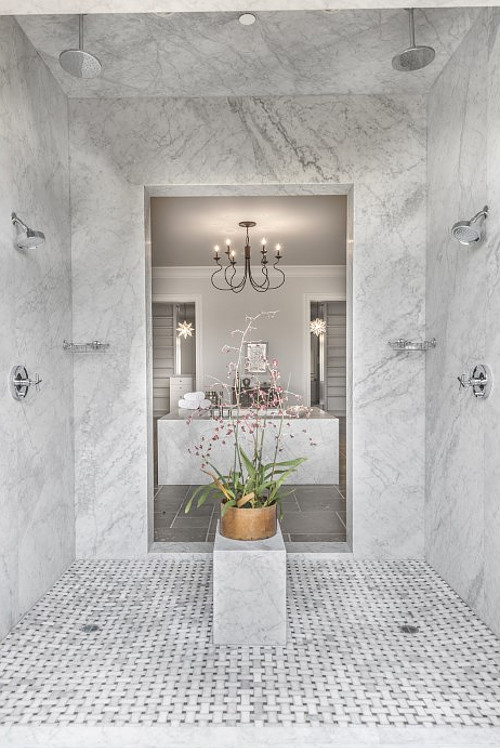 Shower. The walk-in shower features marble slab walls and marble basketweave mosaic tile floors. 