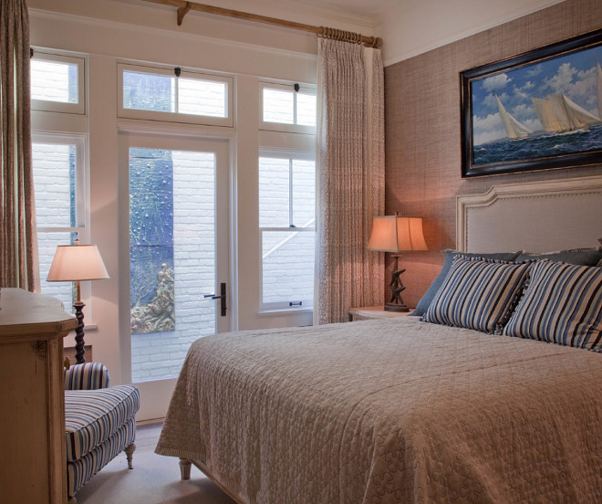 Small Bedroom. Small Bedroom with Doors. Doors in this small bedroom expands this space while grasscloth wallpaper brings warmth. This small bedroom feels cozy and comfy. A door to the garden and floor-to-ceiling windows help to expand this small space. #SmallBedroom #Small #Bedroom #Smallspaces