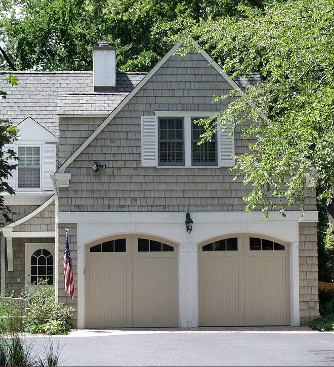 Garage doors are painted cedar. The paint color was custom mix to match the siding stain which is Cabot 'Driftwood Grey'. The siding stain is semi solid and has weathered so looks slightly different than the door color which is a solid color paint. #Garage #Door #PaintColor Brehm Architects.