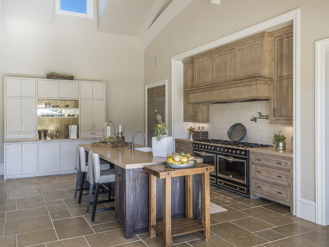 White oak kitchen. French kitchen with White oak kitchen cabinets and island with French Limestone Floor Tiles and French Range. #Whiteoakkitchen