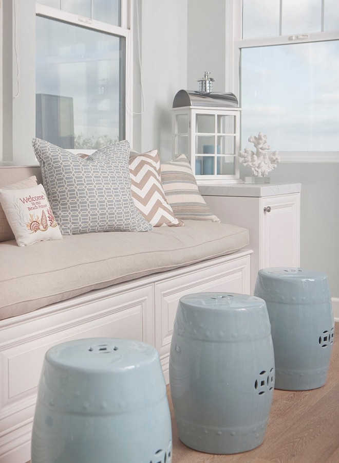 Window seat with coastal pillows. Neutral window seat with coastal pillows and blue garden stools. #Windowseat #coastal #decor #Pillows AGK Design Studio.