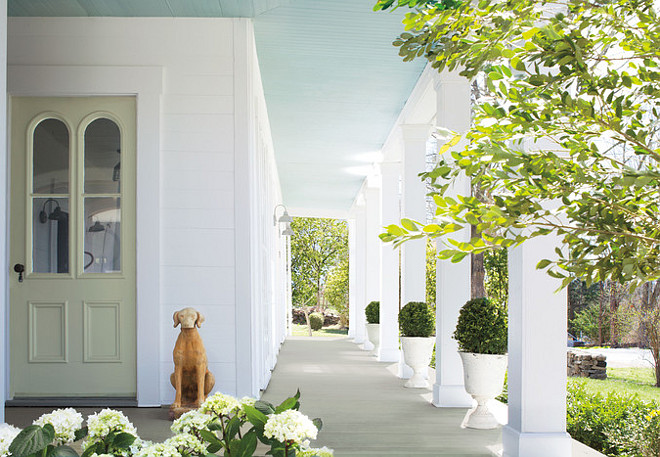Blue Porch Ceiling Paint Color. Blue is the go-to hue for a patio or porch. Benjamin Moore’s Aura, Low Lustre, Harbor Haze 2136-60 (ceiling), Aura, Low Lustre, White Diamond OC-61 (siding), Grand Entrance, Satin, Tree Moss 508 (door) #Blue #Porch #Ceiling #PaintColor Via Bright Nest.
