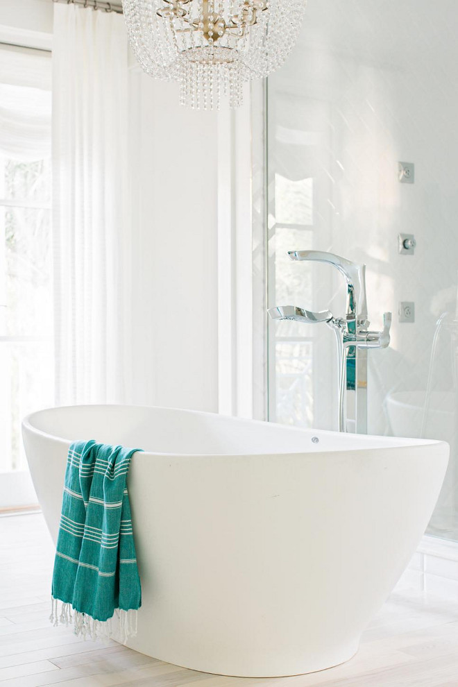 Bathtub. Made of engineered molded stone, the deep tub sits like an elegant piece of furniture in the center of the room.