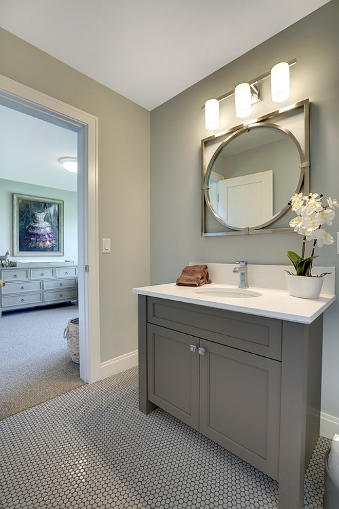 Grey bathroom cabinet paint color. Grey bathroom cabinet paint color suggestions. Grey bathroom cabinet paint color ideas. Grey bathroom cabinet paint color. This bathroom features gray walls, gray vanity and gray penny round floor tiles with dark grout. #Greybathroomcabinet #paintcolor