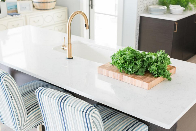 HGTV Dream Home 2016 Kitchen A clean, white, marbled surface on the kitchen island is the perfect backdrop for the patinated brass gooseneck faucet and under mounted sink.