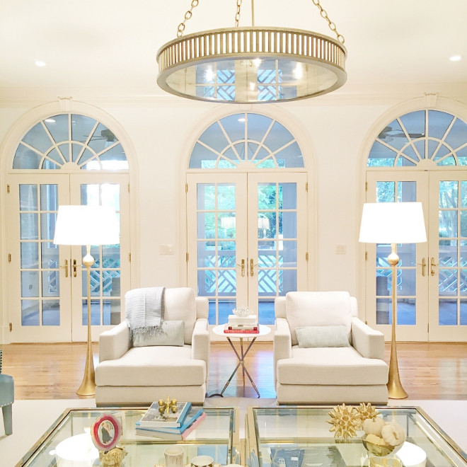 Living room arched doors. All-white living room with gold decor and arched doors. #Livingroom #archeddoors #Livingroomarcheddoors Fashionable Hostess.