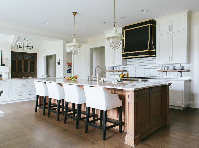 White kitchen cabinet with wood stained island. The white cabinets are custom from Premier Woodworking. #kitchencabinet #customcabinet #customkitchencabinet #customkitchenisland Kate Marker Interiors.