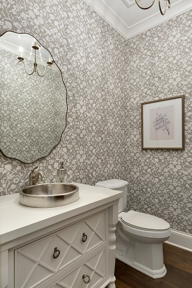 This charming powder room features a gorgeous custom vanity painted in "Benjamin Moore White Dove" and a gray and white floral wallpaper Gray and white Floral Wallpaper, Small bathroom with gray and white floral wallpaper and white vanity #Bathroom #Floral #Wallpaper #GrayWallpaper #Grayandwhite #grayandwhitewallpaper #bathroomwallpaper #smallbathroom 