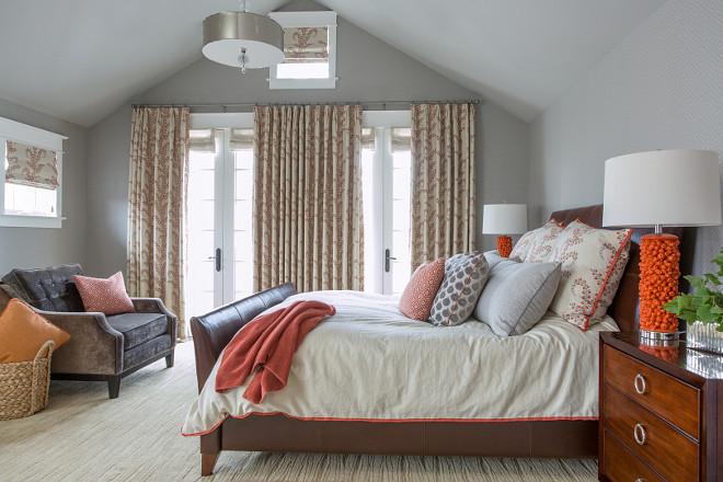 A master suite in gray and orange Walls were covered in a subtle geometric gray on gray wallpaper to act as a backdrop #Masterbedroom #Grayorange #geometricgraywallpaper #geometricwallpaper Alexandra Rae Design