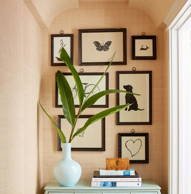 Tan Grasscloth wallpaper, Linen look grasscloth wallpaper, Hallway features tan grasscloth wallpaper with an art gallery over a turquoise blue chest #tangrasscloth #grassclothwallpaper Waterleaf Interiors