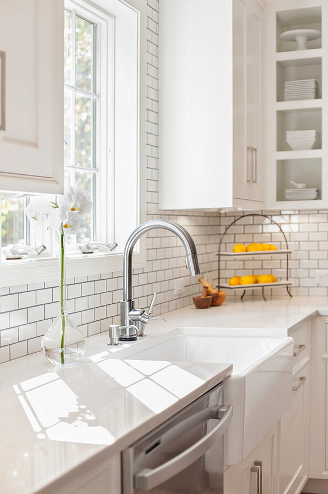 Farmhouse sink with Misty Carrara Caesarstone quartz countertop and subway tile backsplash. New England Design Works