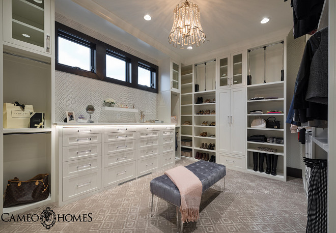 Hers Master Closet with white cabinet and custom dresser with lucite pulls. #Closet #Herscloset #Closetdesign #dressingroom Cameo Homes Inc.