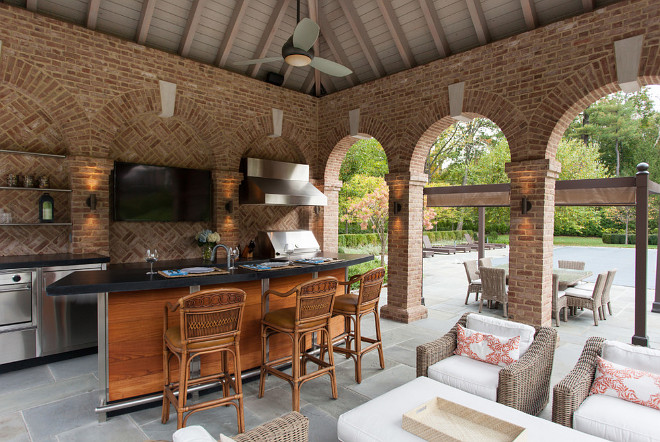 The pool pavilion dining area is serviced by a professional grill and gas oven #PoolHouse #poolPavilion #PoolPavilionInterior #poolPavilionIdeas Douglas VanderHorn Architects