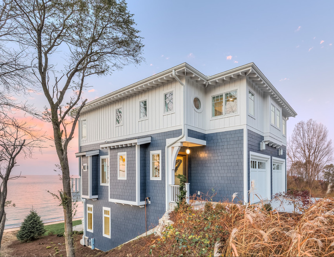 Beach House Exterior Paint Color Inspiration. Beach house painted in vivid blue exterior outlined in white trim balances the soothing hues of the water. #Beachhouseexterior #Beachhouseexteriorpaintcolor Mike Schaap Builders
