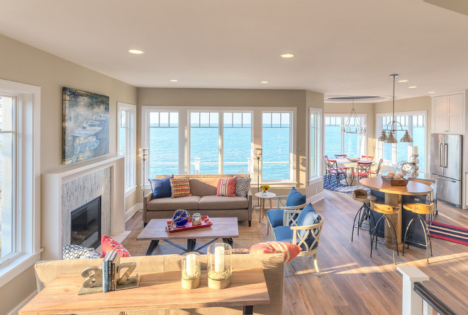 Open Layout Interiors. Tall windows and ceilings flood the main floor with natural light, while white oak floors set the stage for a happy color palette with pops of red and blue. The end result is a relaxed and livable space that remains classic to the core. Mike Schaap Builders