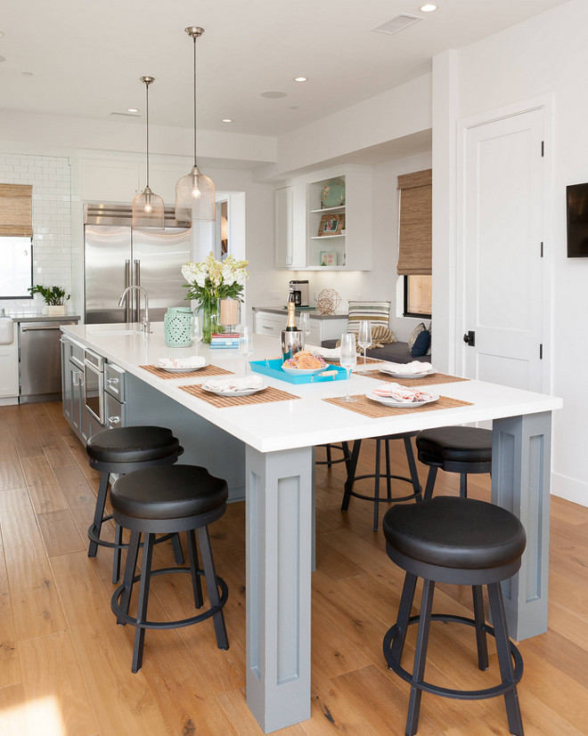 Long gray island with white quartz countertop. Quartz is a relative affordable countertop material and very durable. It's also a good option for long kitchen counters. #Kitchen #QuartzCountertop #Whitequartz #longkitchenislandcountertop Jasmine Roth.