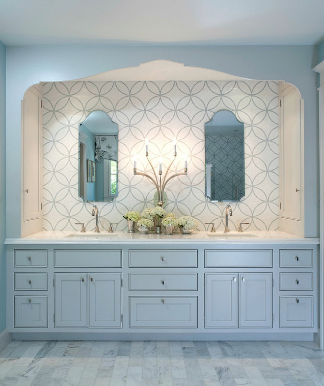 The Master Bath is a peaceful retreat with spa colors. The cabinet and trim are Benjamin Moore Light Pewter. The woodwork is painted a pale grey to pick up the veining in the marble. The mosaic tile behind the mirrors adds pattern. Built in side cabinets store everyday essentials. #BenjaminMooreLightPewter. Johnston Home LLC