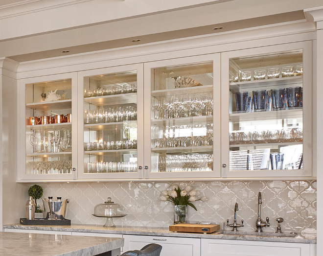 Kitchen Bar Glass Door Cabinet. The kitchen bar features glass cabinet doors with mirrored back and white Arabesque backsplash tile Kitchen Bar Cabinet with Glass Doors and Mirrored Back. #Kitchen #Bar #KitchenBarCabinet #BarCabinet #Cabinetglassdoor Asher Associates Architects. Megan Gorelick Interiors