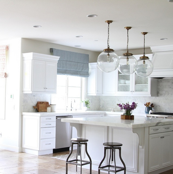 One of my favorite elements of the kitchen are the glass, globe, pendant lights. I love the mix of the metals in the kitchen from the antique brass on the lights. #Kitchenpendants #Globependants