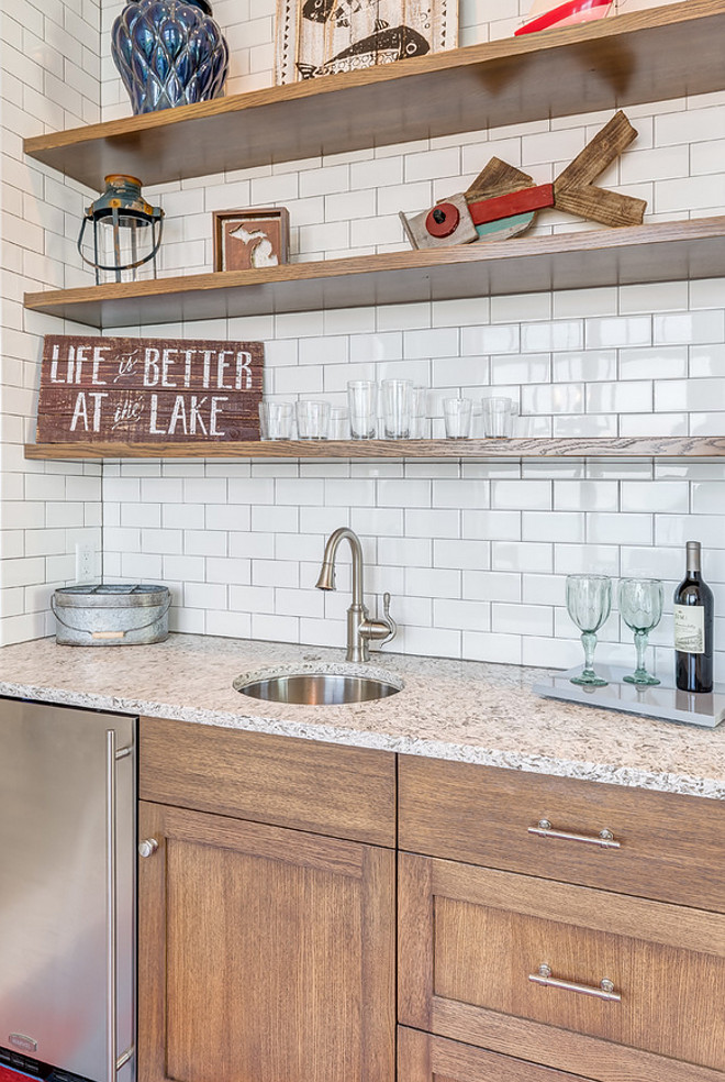 Rustic Butlers pantry with floating shelves and subway tile backsplash. Mike Schaap Builders