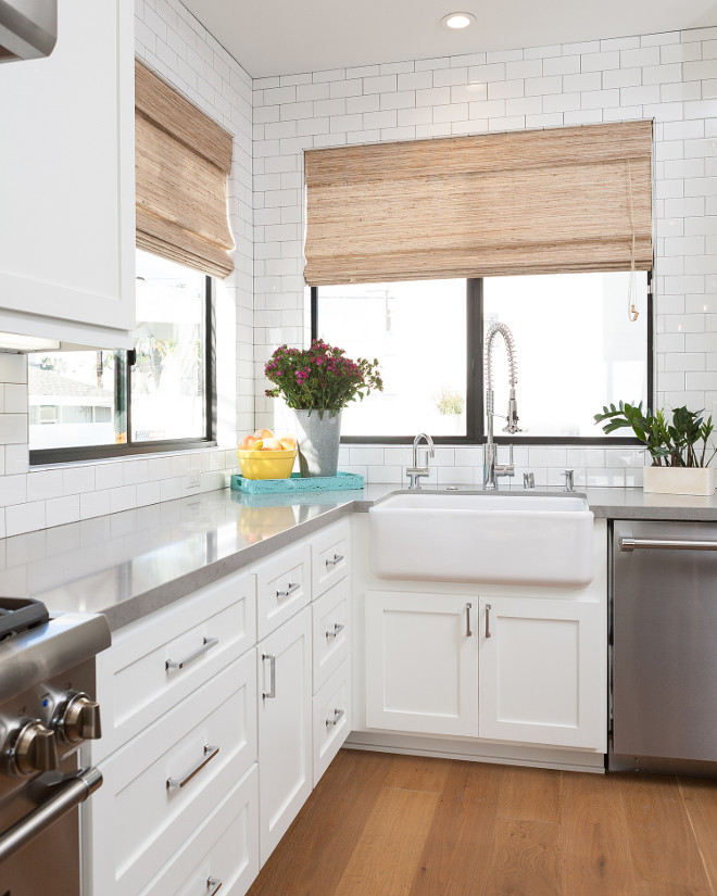 Sleek white kitchen with shaker style cabinet doors, gray quartz countertop and counter to ceiling subway tile. #Shakercabinet #shakerstylecabinet #shakerstylecabinetdoor #kitchenshakerstylecabinet Jasmine Roth.