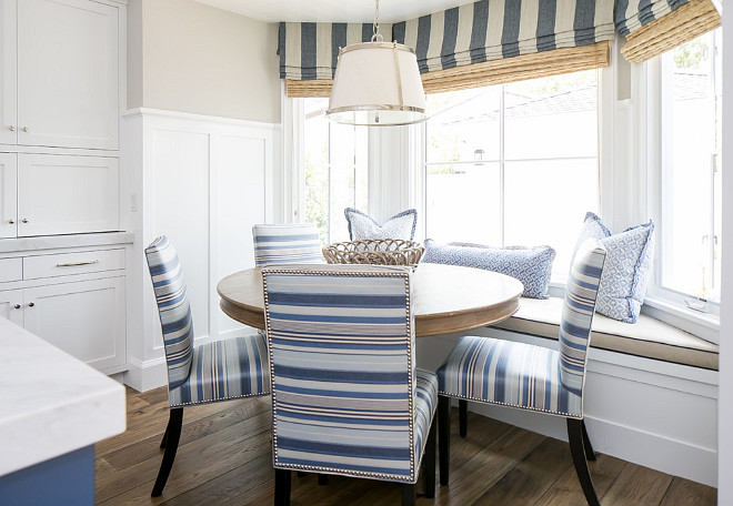 Breakfast Nook Windows. Breakfast nook windows feature striped roman valances with woven shades underneath. #BreakfastNook #BreakfastNookWindows #BreakfastNookRomanshades #BreakfastNookShades #BreakfastNookWovenShades #Wovenshades #Romanshades #windowshades