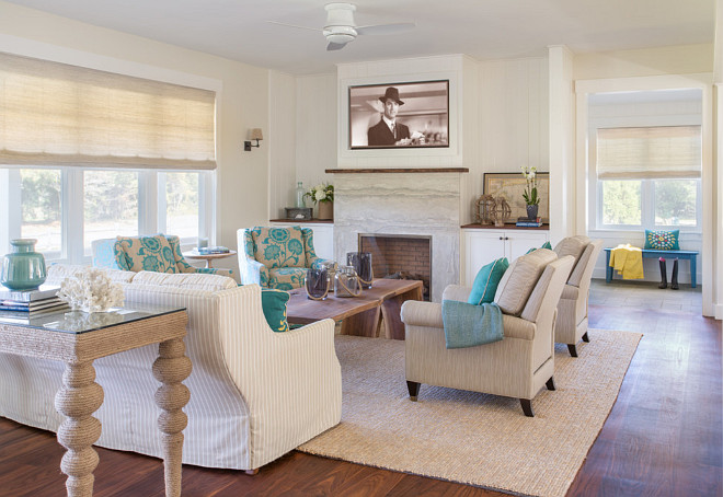 Beach style living room. Beach house living room with neutral slipcovered furniture, turquoise accents and a fireplace surround with quartzite. Neutral beach style living room. #livingroom #neutralbeachhouse #beachhouselivingroom Martha's Vineyard Interior Design