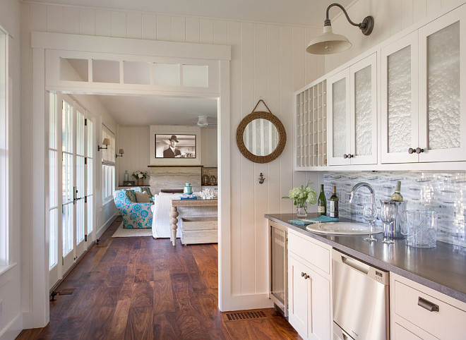 Butlers pantry features wide plank hardwood floors and vertical wall paneling. #butlerspantry #wideplankfloors #verticalpaneling #wallpaneling Martha's Vineyard Interior Design