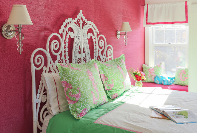 Girls Bedroom with pink grasscloth wallpaper and sconces above bed. A window seat is tucked across the bed. #kidsbedroom #girlsbedroom Martha's Vineyard Interior Design