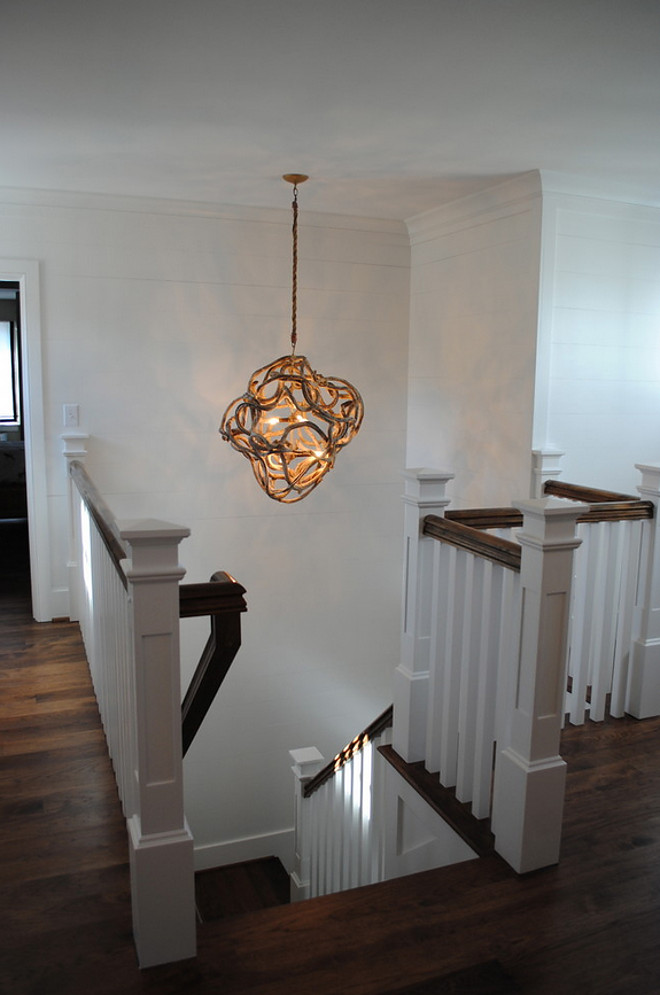 Stairway Lighting. Staircase features hallway wrapped in 1 x 10. Light fixture, driftwood by Low Country. Stacye Love Construction & Design, LLC