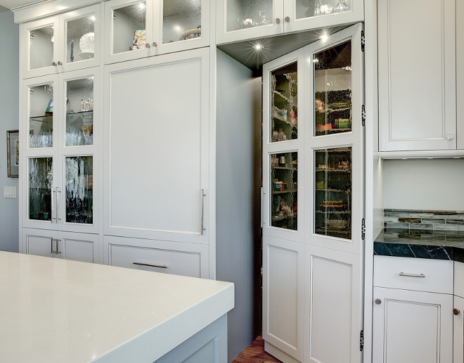 Kitchen pantry cabinet. Concealed pantry door and cabinetry with seedy antique glass inserts. Kitchen pantry cabinet. Kitchen pantry. #Kitchenpantry #Kitchenpantrycabinet #Kitchencabinet Kitchen #pantry Benchmark Design Studio