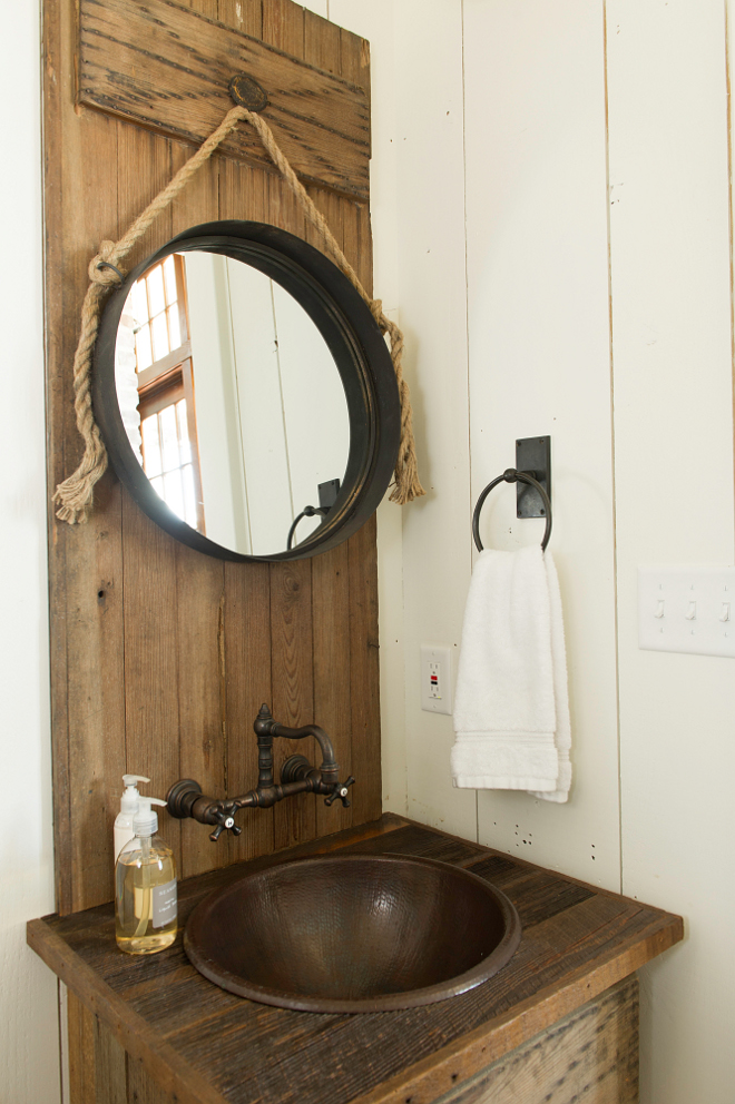 Rustic Powder room. Vanity and wood behind vanity was made of reclaimed door from home owner’s property. Wall Color – Benjamin Moore White Dove Hardware – Ashley Norton Sink – Linkasink Wall mounted Faucet – Cifial. Rope Mirror – provided by owner. #RusticInteriors #Rusticbathroom #rusticpowderroom #rusticvanity #relacimedwoodvanity #reclaimedvanity Interiors by Courtney Dickey and T.S. Adams Studio.