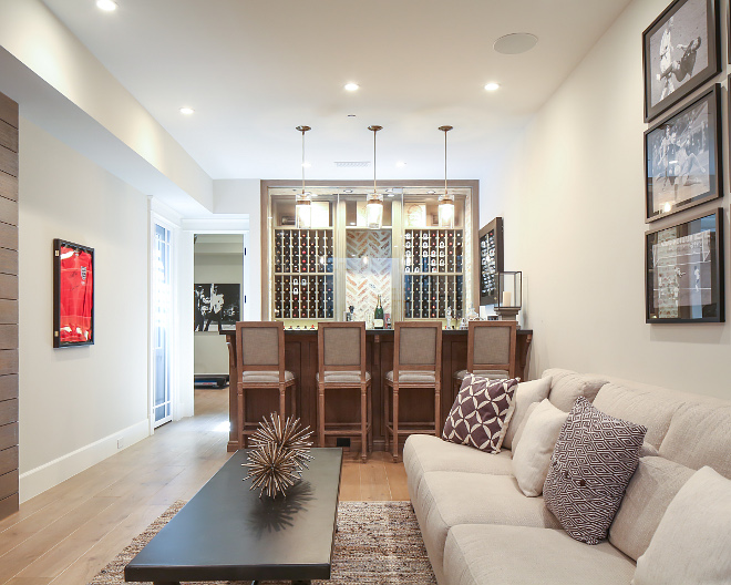 Basement Bar Ideas. A neutral color palette keeps this entire space feeling welcoming and elegant. Patterson Custom Homes. Interiors by Trish Steele, Churchill Design.